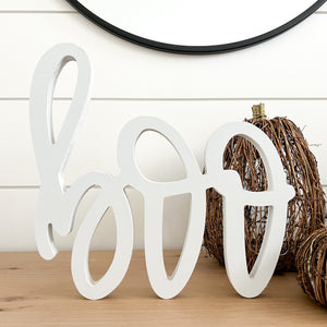 Hand-lettered "boo" wood sign in white