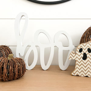 Hand-lettered "boo" wood sign in white